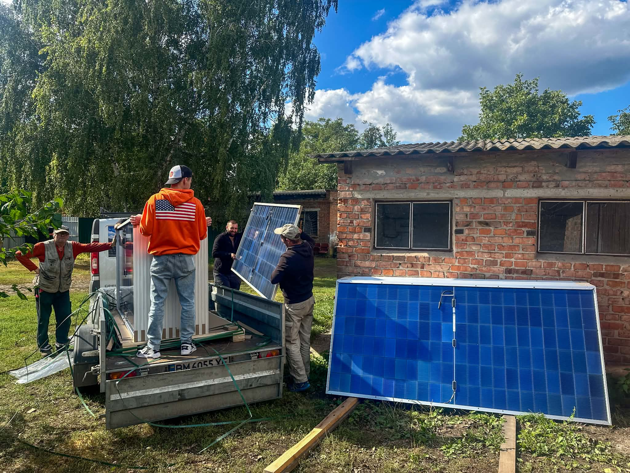 Solar panels being unloaded from a trailer as work begins on a new solar power system at the Centre.